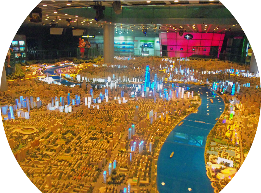 Large model of a city with some building glowing blue.